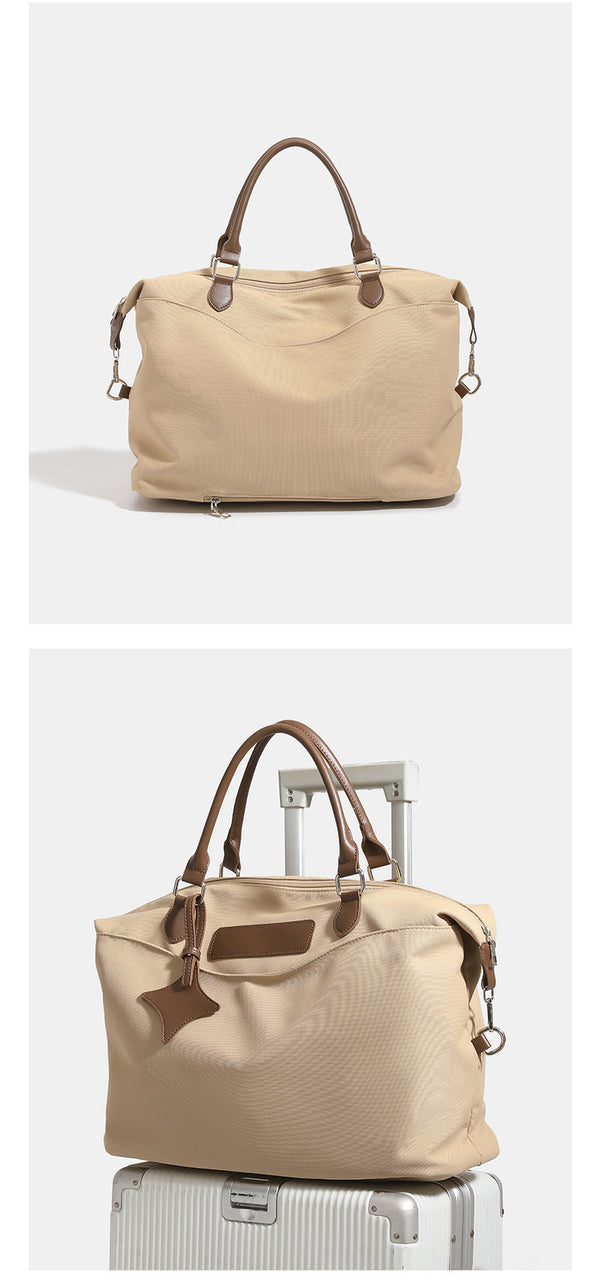 Large slouchy nylon tote bag with brown leather-look handles, double-pull zip closure, and star charm detail, detail view 13