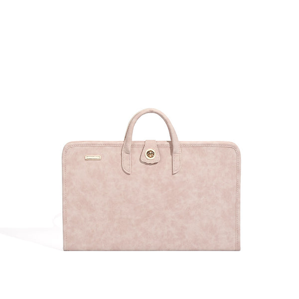 Blush pink structured flat tote bag with matte textured finish, dual top handles, and gold-tone twist clasp, detail view 5