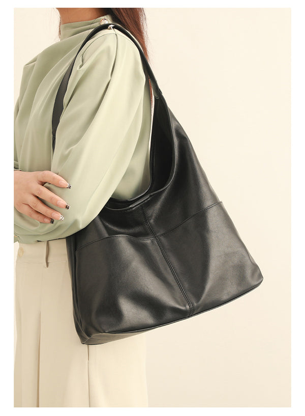 Oversized slouchy hobo tote bag in dark brown smooth matte leather-look finish with long flat shoulder strap and panelled