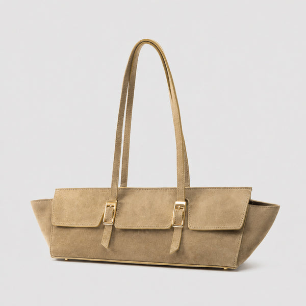 Wide trapezoid tote bag with matte suede-like finish, dual gold-tone buckle front pockets, and double flat shoulder straps