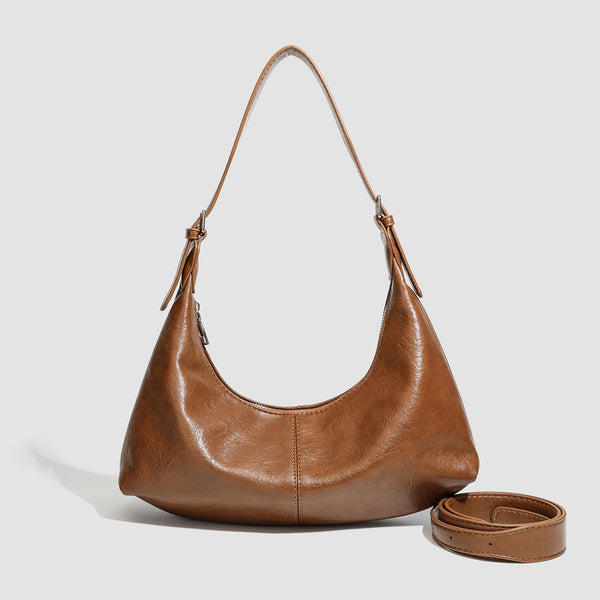Slouchy crescent hobo shoulder bag with zip-top closure and adjustable strap, front view