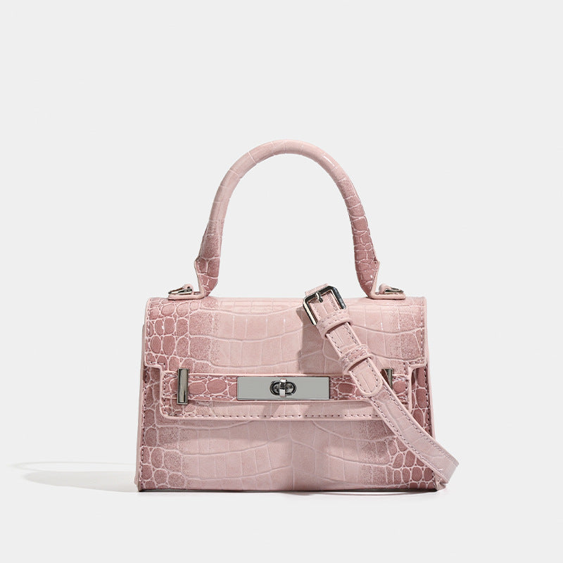 Structured mini top-handle bag in glossy croc-embossed leather-look finish with silver-tone turn-lock hardware and