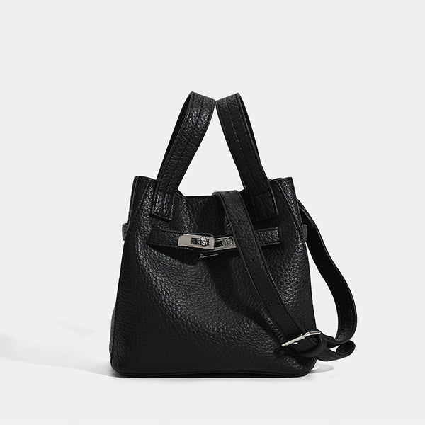 Small structured pebbled leather-look bucket bag with silver turn-lock bar hardware and dual top handles, detail view 6