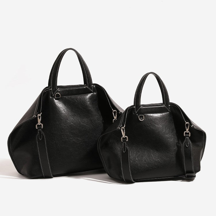 Structured cognac brown leather-look tote bag with fold-ear side panels, top handles, gold-tone hardware, and detachable