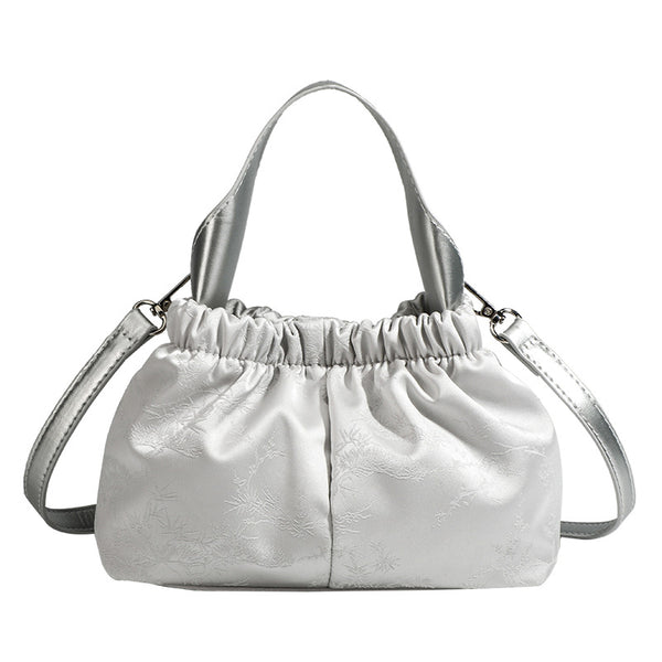 Small ruched satin-finish cloud bag with elasticized drawstring top, short top handle, and chunky silver-tone chain strap