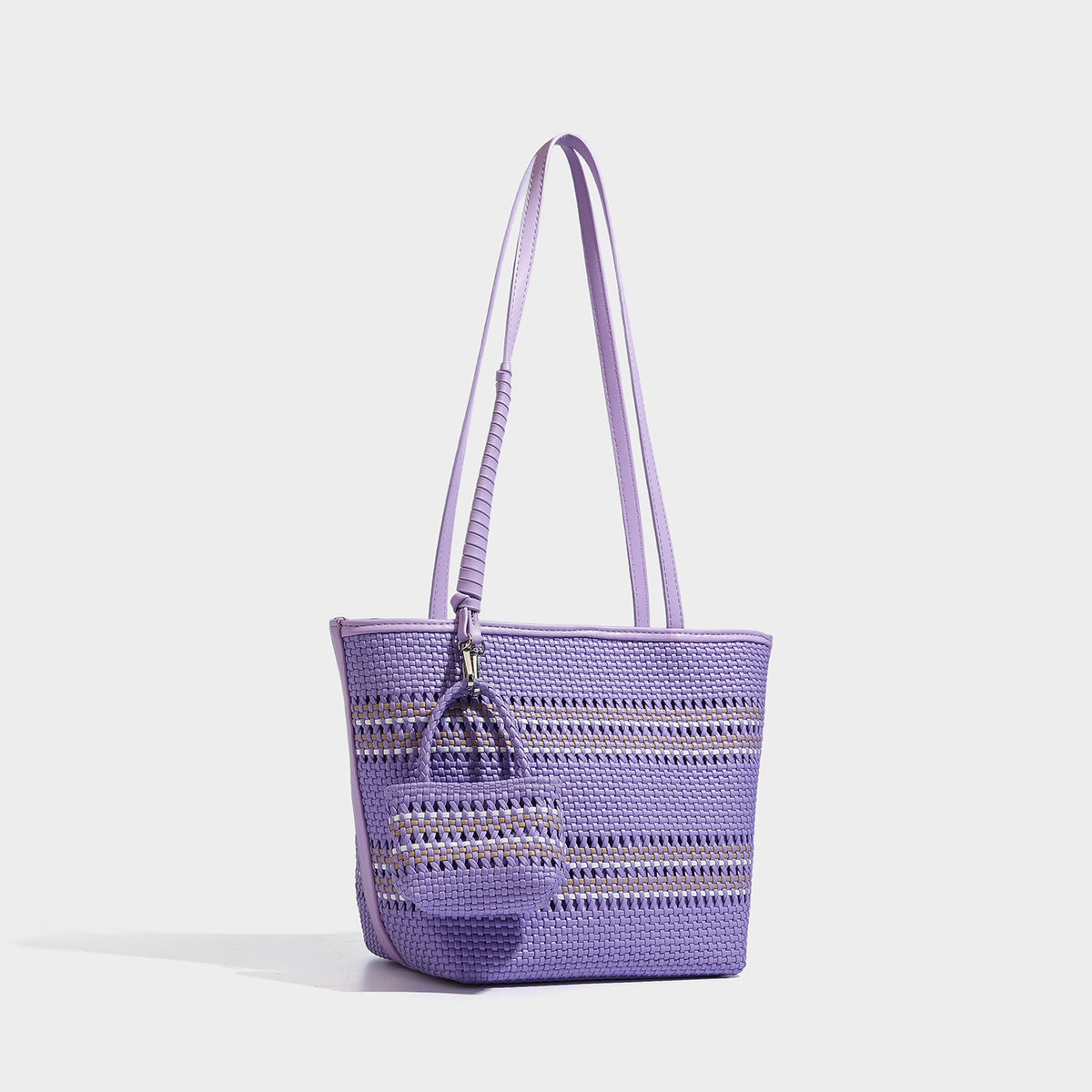 Large structured woven tote bag with striped basket-weave finish, long shoulder straps, and detachable mini pouch charm