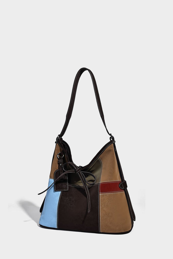 Patchwork bucket tote shoulder bag with tan, dark brown, olive, red, and sky blue color-block panels, white contrast, detail