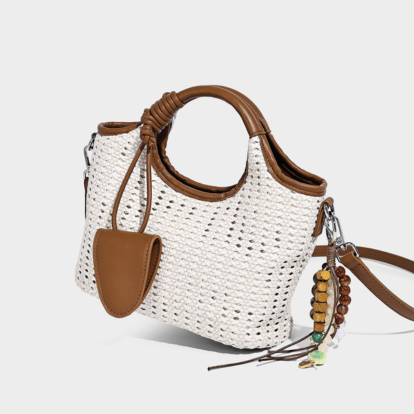 Small structured woven tote crossbody bag with ring top handle, leather-look brown trim, front patch pocket, and detachable
