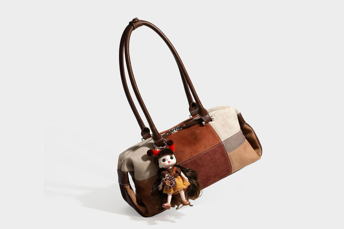 Patchwork suede-look barrel shoulder bag in brown, rust, tan, beige, and gray panels with double leather-look straps and
