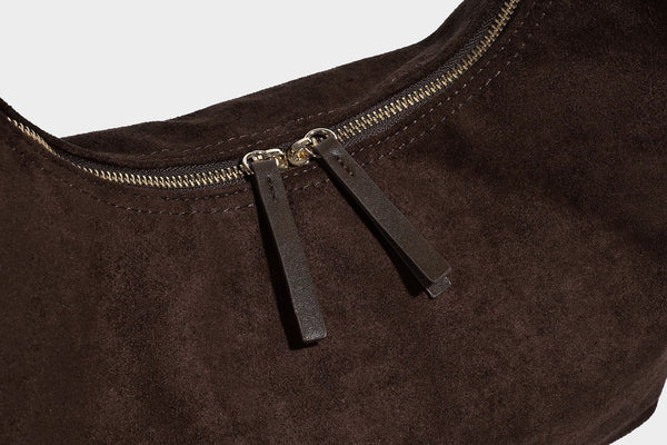 Slouchy crescent hobo shoulder bag in dark chocolate matte suede-look finish with adjustable strap and twin-pull top zip