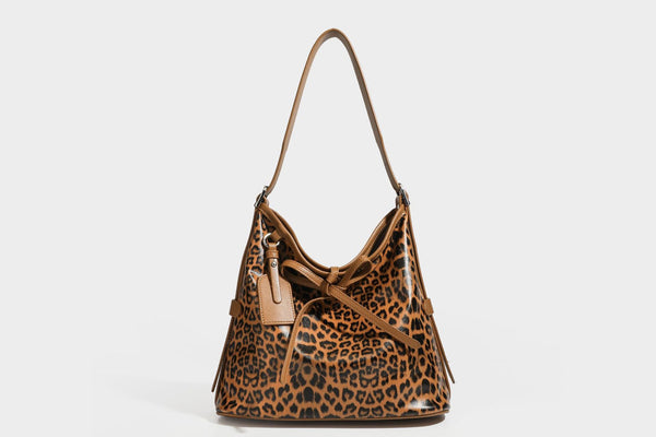 Slouchy leopard print shoulder hobo bag with black leather-look trim, tie-top closure, and single long strap, detail view 25
