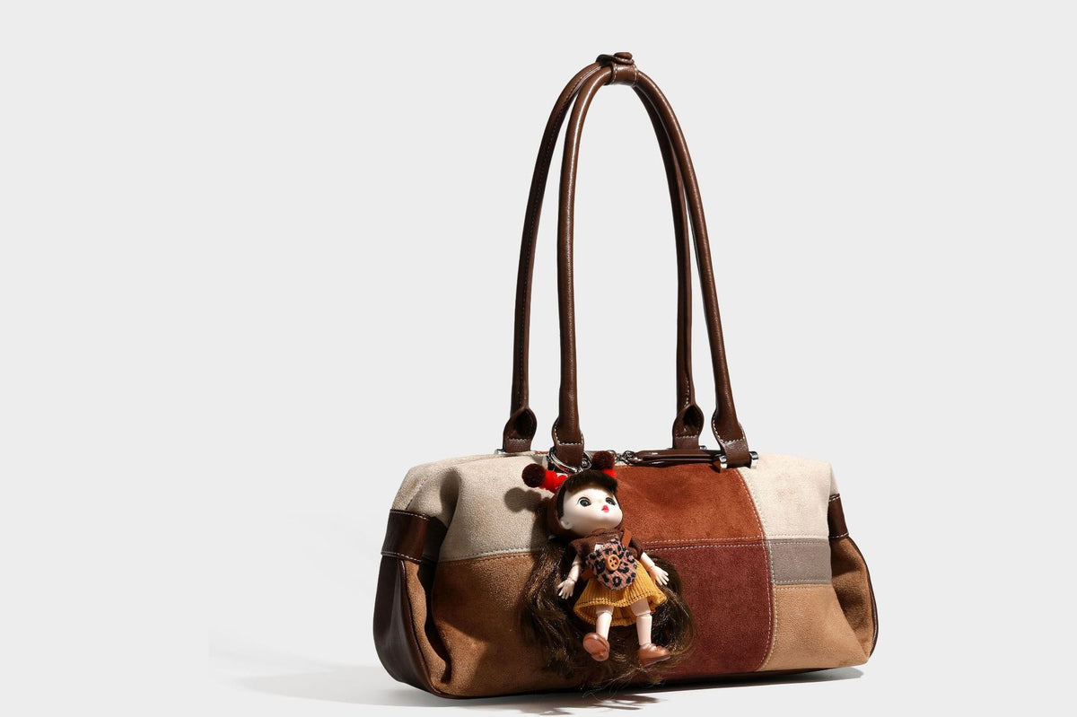Patchwork suede-look barrel shoulder bag in brown, rust, tan, beige, and gray panels with double leather-look straps and