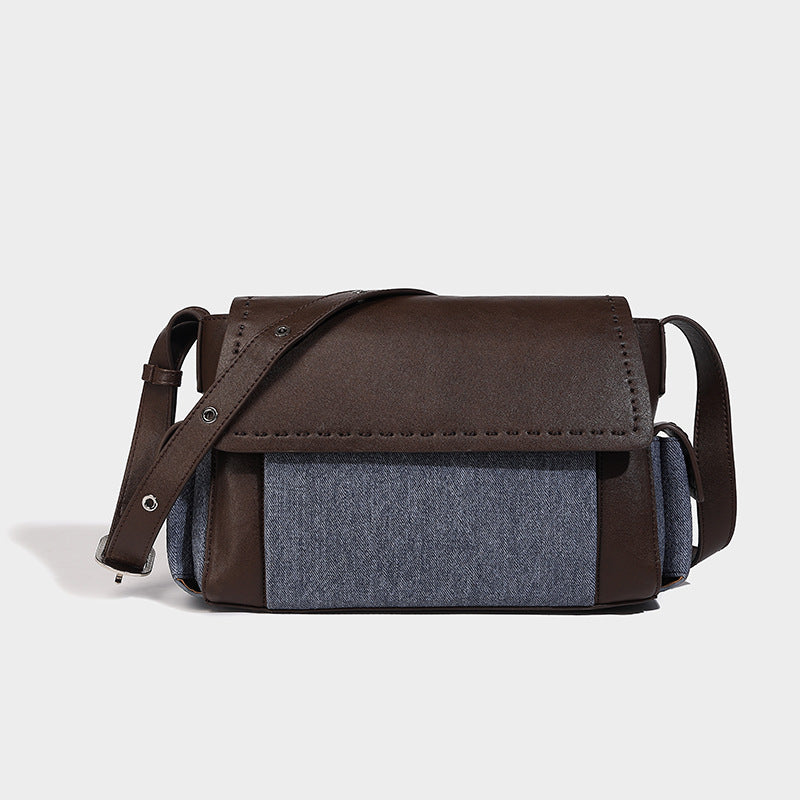 Structured flap crossbody bag in dark brown and cream color-block with white contrast stitching, adjustable shoulder strap