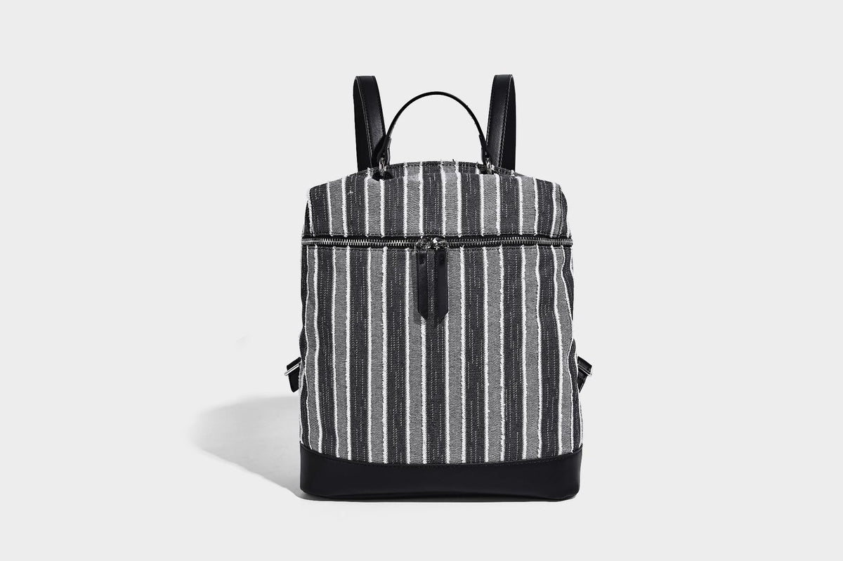 Small structured striped fabric backpack handbag with cream leather-look trim, top handle, and silver-tone hardware, detail