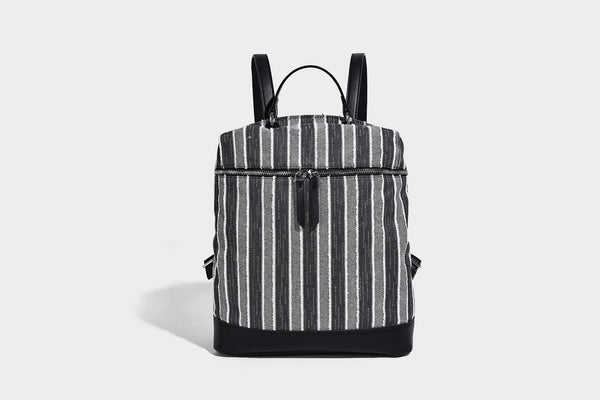 Small structured striped fabric backpack handbag with cream leather-look trim, top handle, and silver-tone hardware, detail