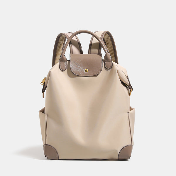 Soft rectangular nylon convertible backpack handbag with leather-look trim, snap-flap closure, top carry handles, padded