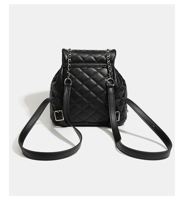 Black diamond-quilted backpack handbag with silver-tone chain flap accent and adjustable shoulder straps, detail view 14