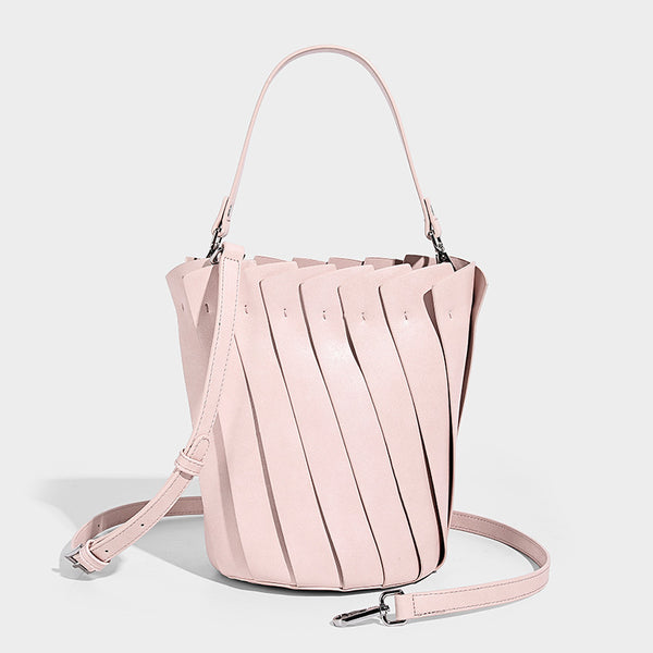 Structured pleated-panel bucket bag with curved top handle and detachable adjustable shoulder strap in smooth matte, front