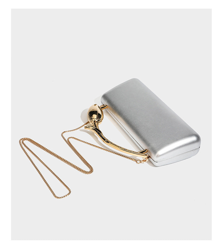 Formstabile, rechteckige Clutch mit Henkel in Rosenknospenform in Goldoptik und abnehmbarem Kettenriemen in Metallic-Optik, Detail
