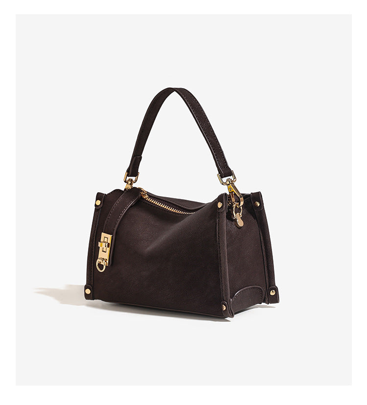 Small structured square handbag in deep dark brown matte pebbled finish with gold-tone turn-lock clasp, top zipper, corner
