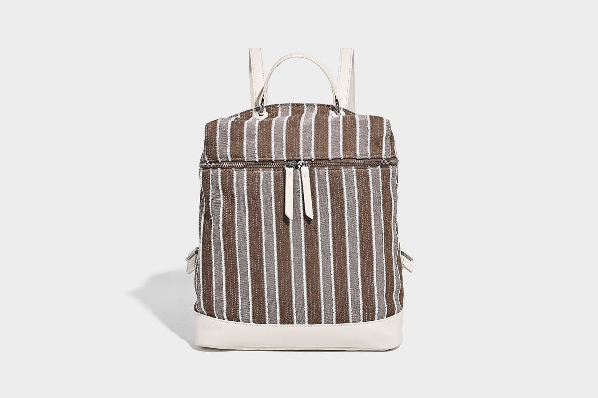 Small structured striped fabric backpack handbag with cream leather-look trim, top handle, and silver-tone hardware, detail
