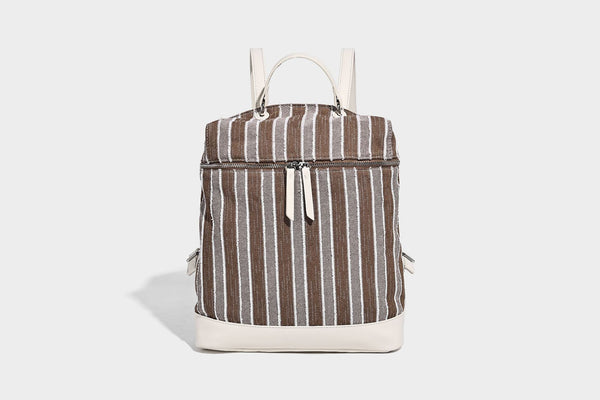 Small structured striped fabric backpack handbag with cream leather-look trim, top handle, and silver-tone hardware, detail
