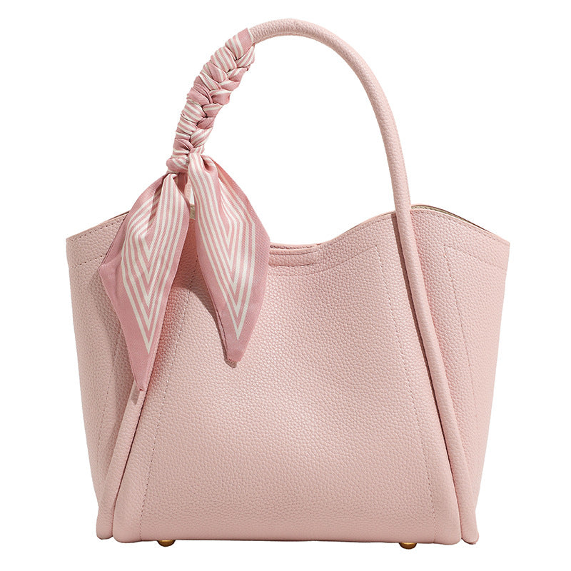 Pebbled leather-look bucket tote bag with scarf-wrapped top handle and gold-tone hardware, detail view 5