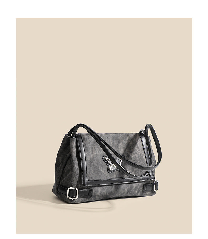 Washed leather-look shoulder tote bag with silver butterfly emblem and buckle hardware, detail view 8