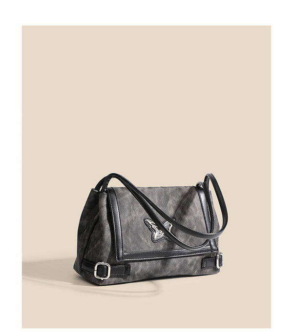 Washed leather-look shoulder tote bag with silver butterfly emblem and buckle hardware, detail view 8