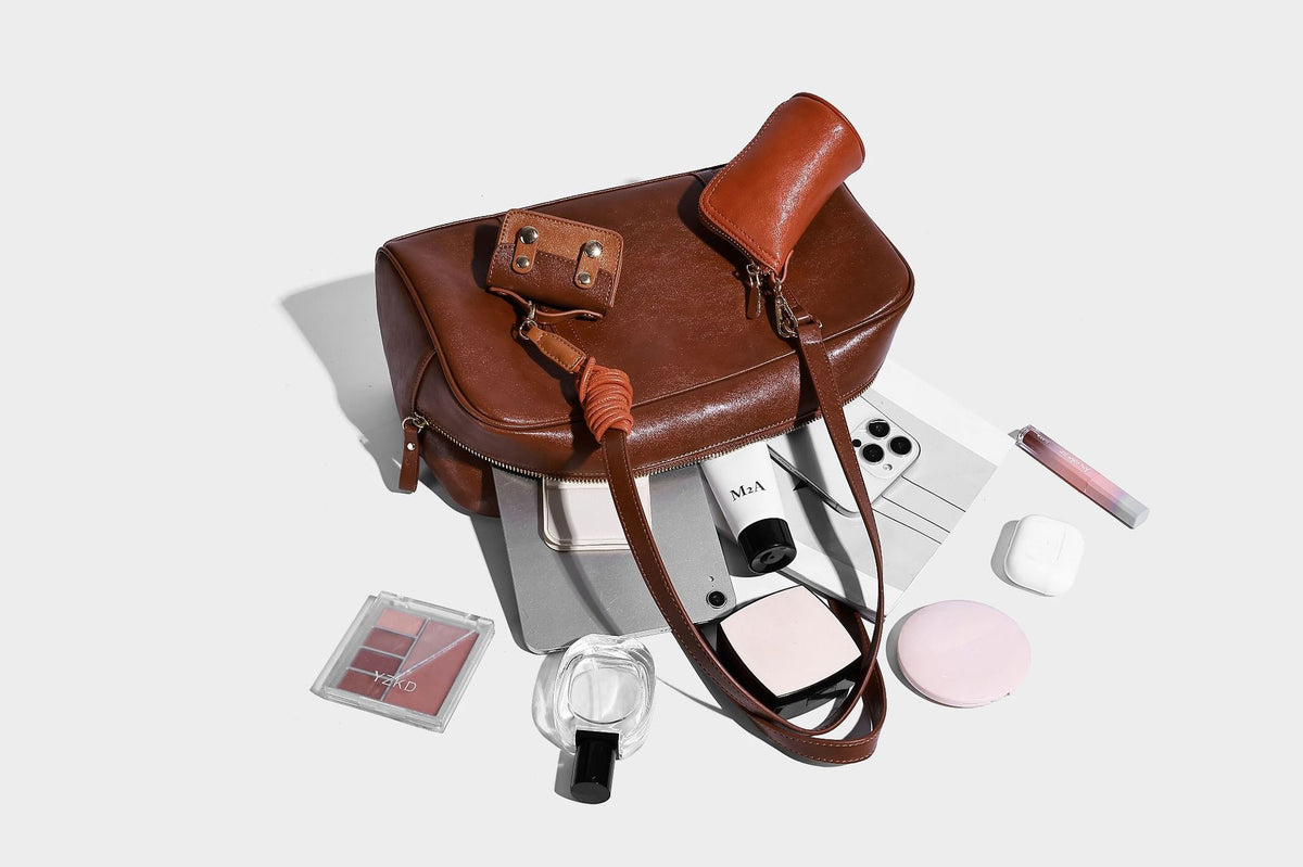 Strukturierte Boston-Schultertasche in glänzender Lederoptik mit zwei langen Trageriemen, Reißverschluss oben, goldfarbenen Beschlägen und zwei