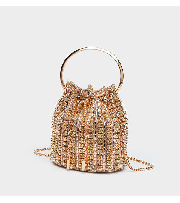 Mini crystal rhinestone bucket bag with circular ring top handle, drawstring closure, and silver chain shoulder strap, detail
