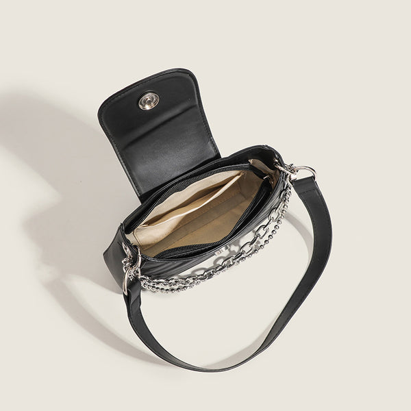 Small trapezoid shoulder bag with ripple leather-look finish, silver butterfly front clasp, and layered chain-and-ball strap