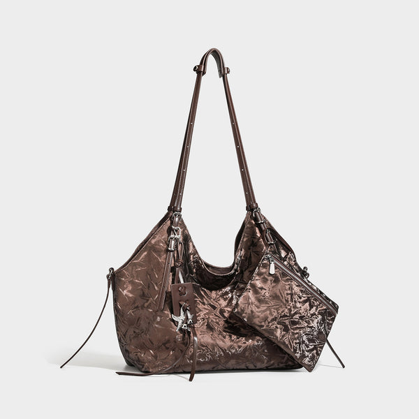Slouchy crinkle-finish shoulder tote bag with silver hardware and attached zip pouch, front view