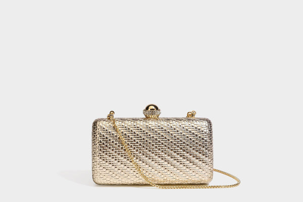Small structured metallic woven-texture box clutch bag with jeweled kiss-lock dome clasp and slim gold chain strap, detail