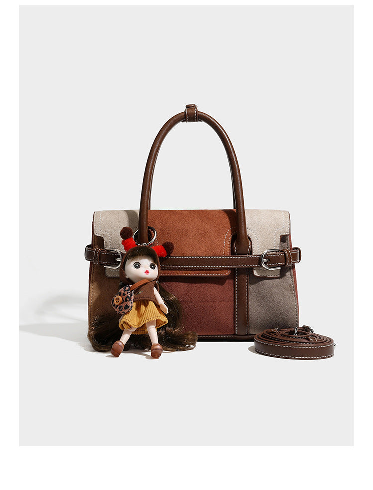 Structured color-block satchel bag in brown, rust, beige, and taupe suede-look panels with white topstitching, front buckle