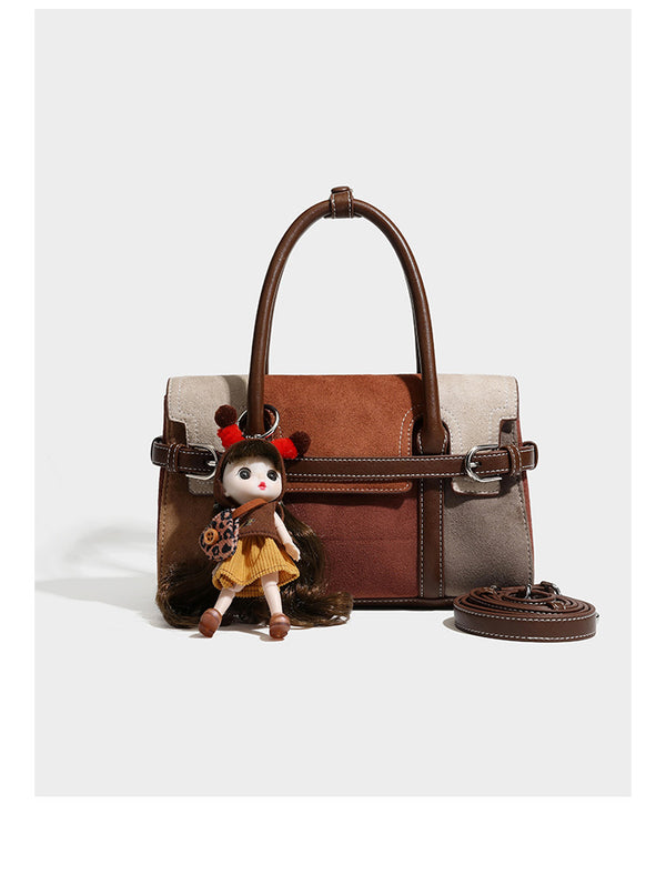 Structured color-block satchel bag in brown, rust, beige, and taupe suede-look panels with white topstitching, front buckle