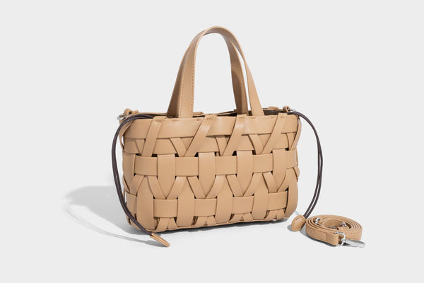 Structured woven basket tote handbag with contrasting dark trim, double top handles, detachable shoulder strap, and
