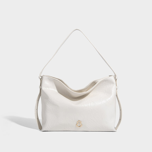 Large slouchy hobo shoulder bag in glossy crinkle leather-look finish with gold-tone emblem hardware and adjustable strap