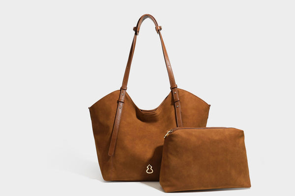 Oversized suede-finish tote shoulder bag in caramel brown with slim leather-look straps and gold-tone logo hardware, detail