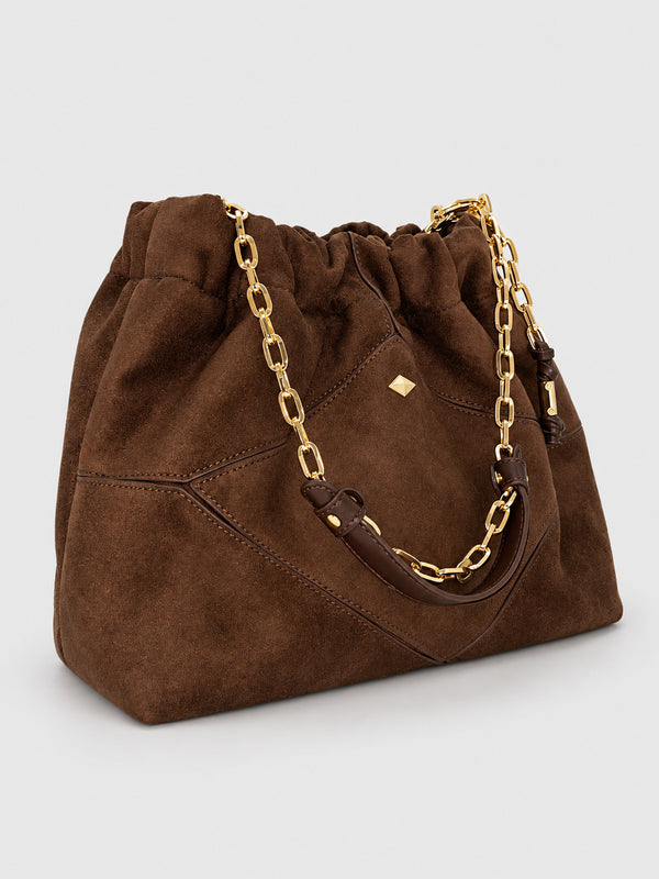 Slouchy suede-look shoulder bag with gathered top, angular stitched paneling, and chunky gold-tone chain strap, detail view