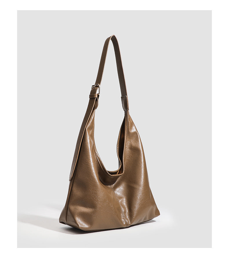 Large slouchy hobo shoulder bag in smooth leather-look finish with adjustable strap and gold-tone hardware, detail view 17