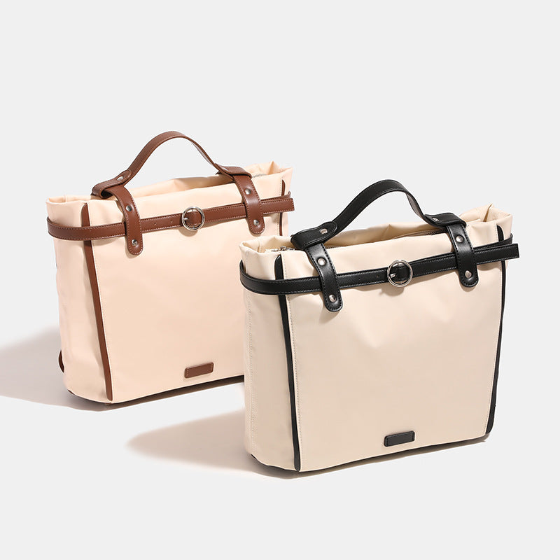 Large cream nylon tote bag with leather-look belt straps and silver-tone hardware, front view