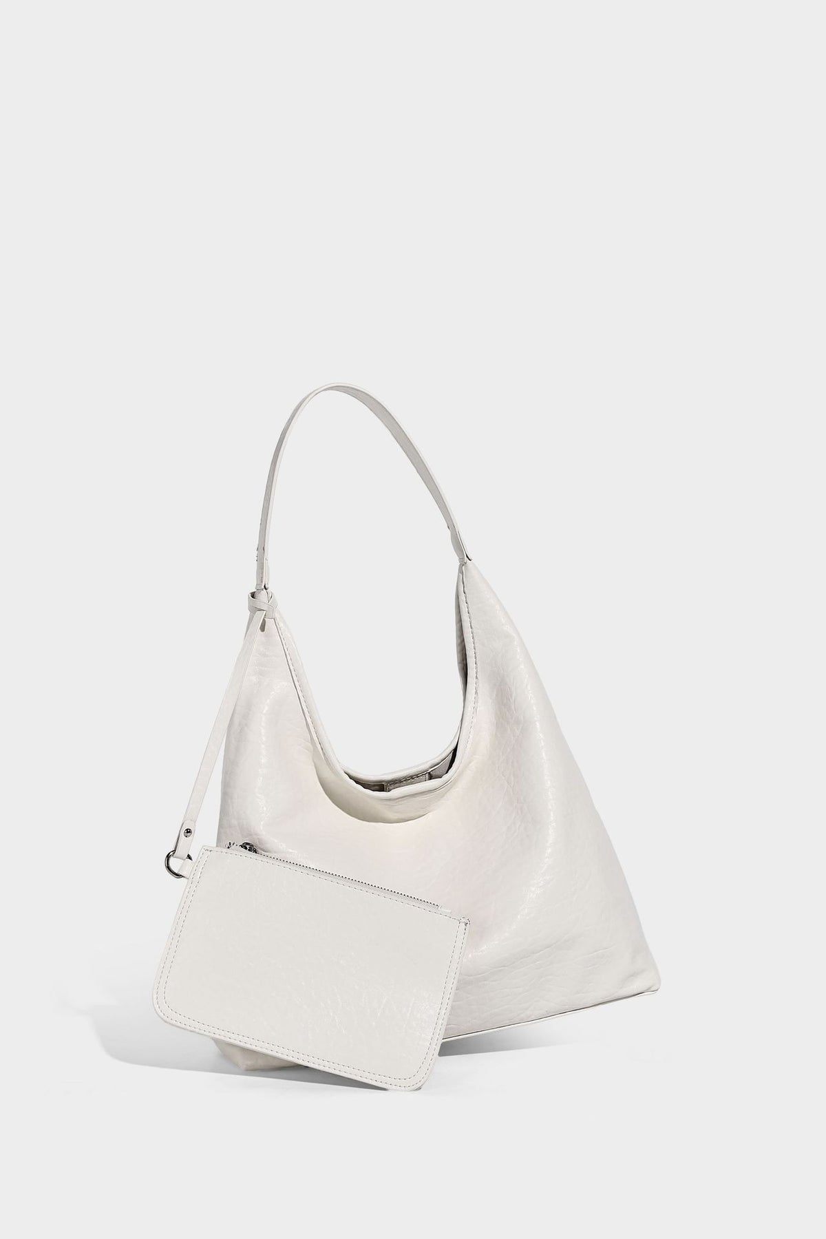 Slouchy hobo shoulder bag in pale yellow glossy pebbled leather-look finish with single shoulder strap and detachable front