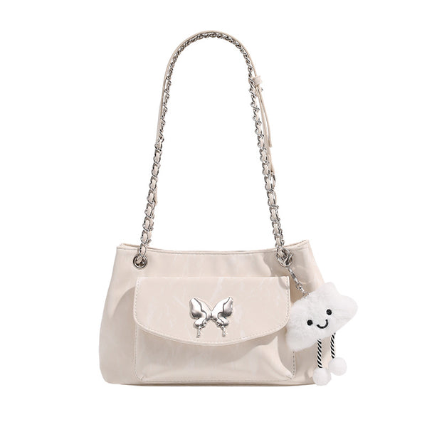 Soft rectangular glossy leather-look shoulder bag with silver chain strap, butterfly ornament on front flap pocket, and