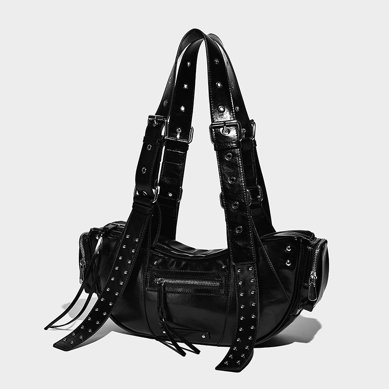 Glossy black crescent shoulder bag with silver-tone rivets, multiple zip pockets, and long adjustable studded straps, front