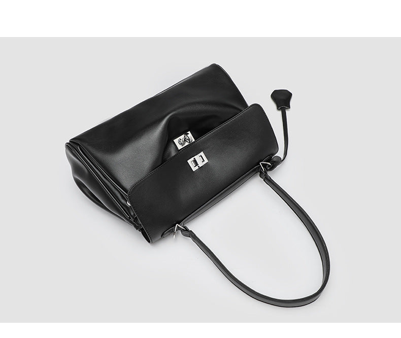 Structured black leather-look flap satchel bag with silver turn-lock hardware and top handle, detail view 13