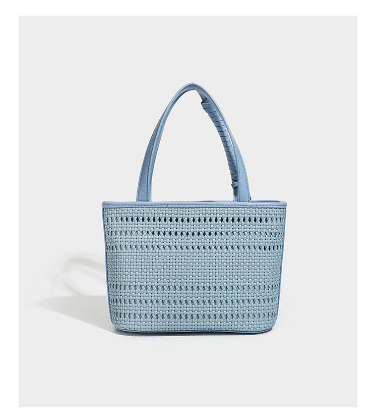 Structured open-weave tote bag with smooth leather-look trim, double top handles, detachable crossbody strap, and mini zip