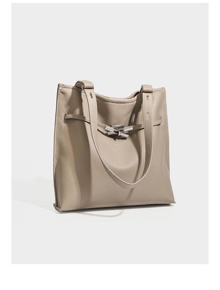 Pebbled leather-look tote bag with front toggle hardware and long shoulder strap, detail view 7