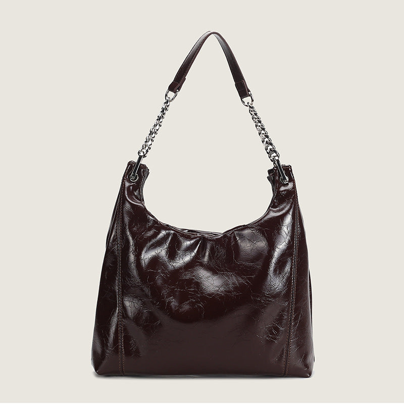 Glossy crinkled leather-look slouchy hobo bag with silver chain-and-leather shoulder strap and open top, detail view 6