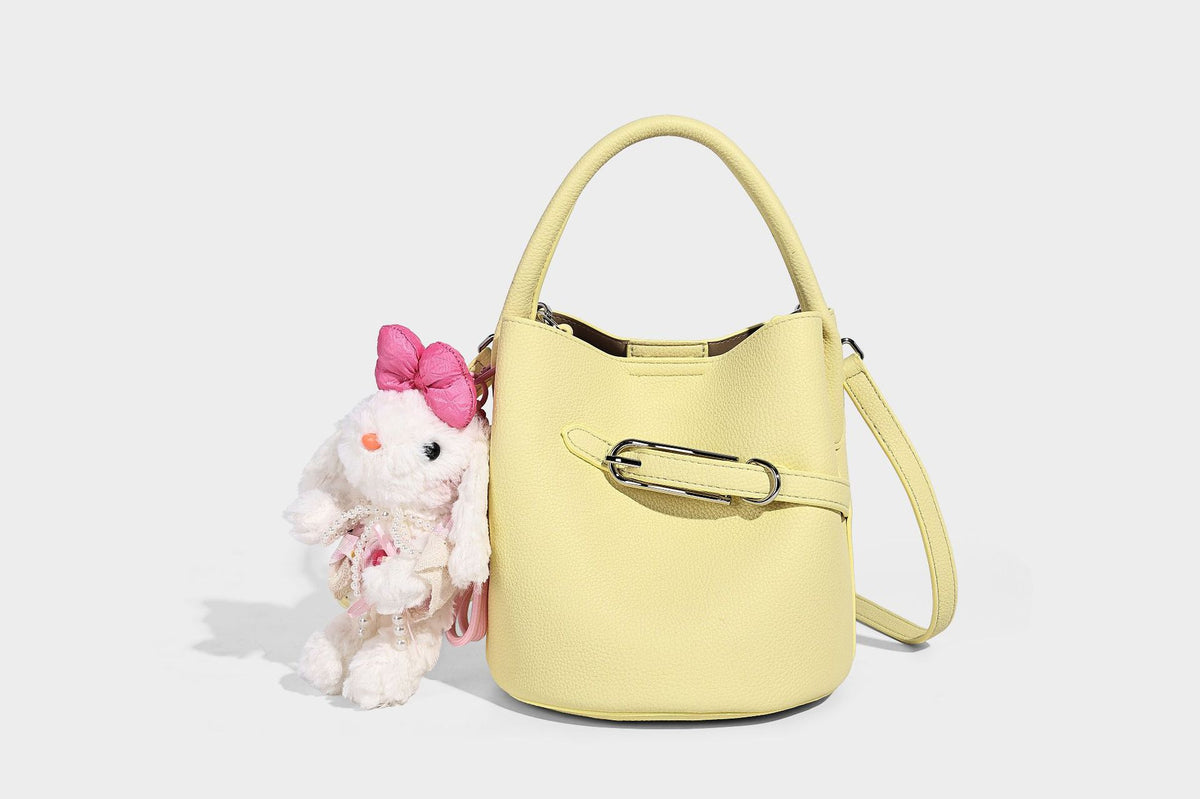 Mini pebbled leather-look bucket bag with front buckle strap, silver-tone hardware, top handle, and detachable shoulder